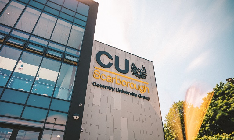 The CU Scarborough campus building with blue skies above