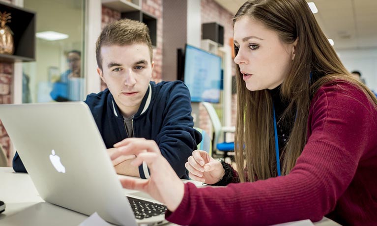 students working on a laptop