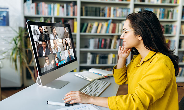A woman sat at her desk, during an online conference call
