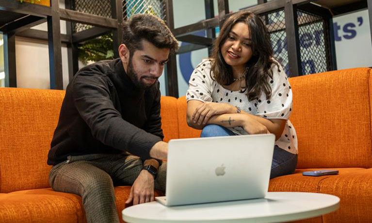Woman and man looking at a laptop