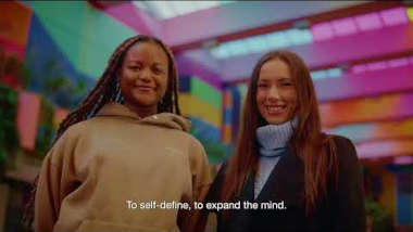 Two students stood in a colourful alley