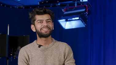 Hassan Nathani sitting in a film studio