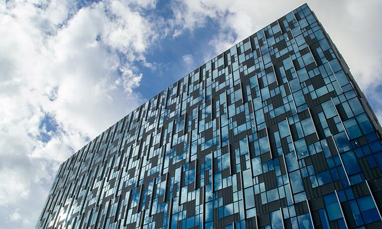 Outside of the Greenwich building looking up to the sky