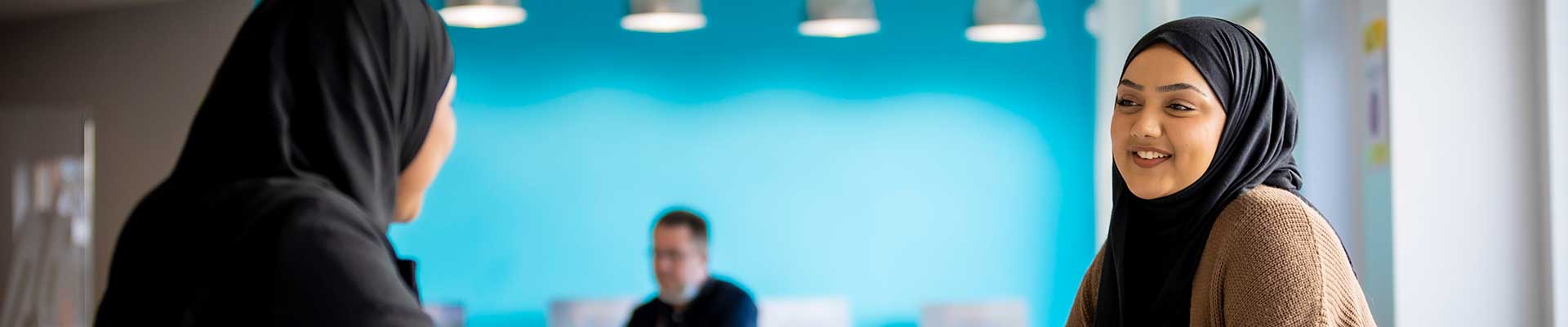 Two people sat at a desk
