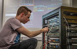 Student working on computer hardware