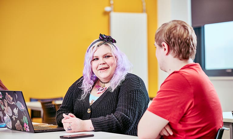 Two students facing each other and talking
