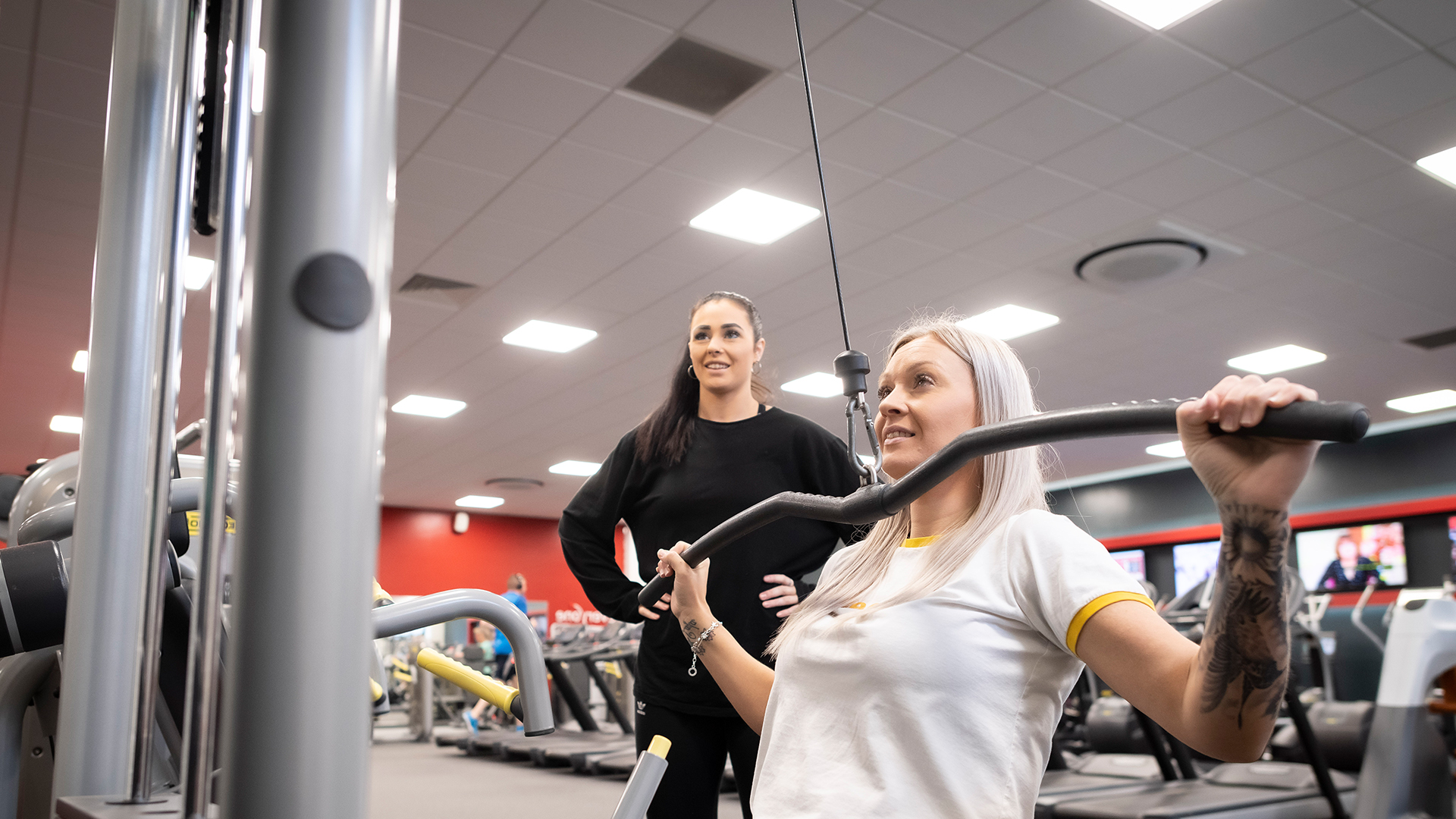 Sport Performance & Coaching students using gym equipment and spotting each other