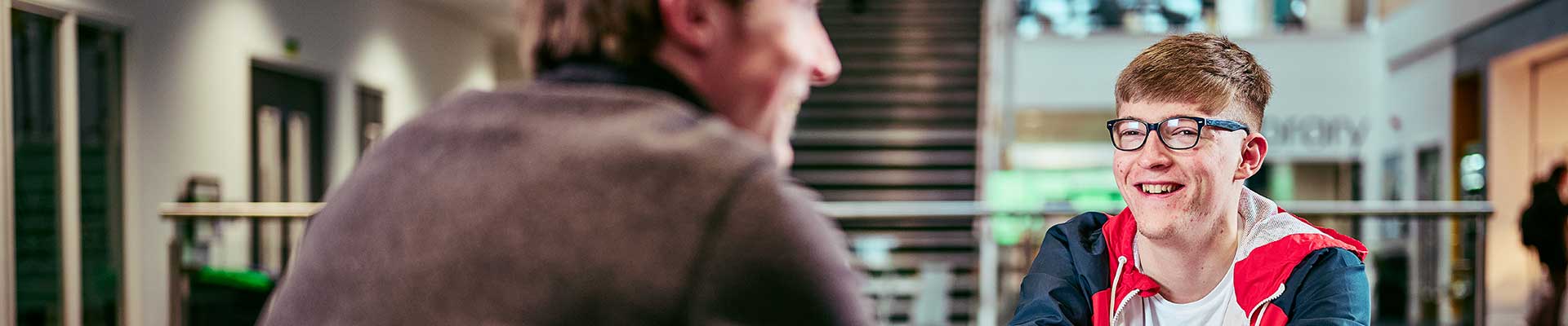 Two people sat opposite each other talking