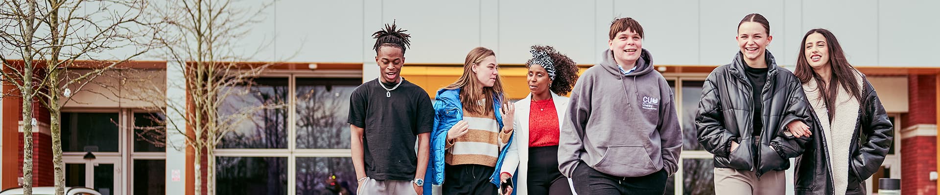 Large group of students walking together and smiling