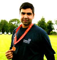 Sanchit Guliani holding a bronze medal