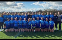 Coventry University Ladies Gaelic Football team lined up with the British University Championship trophy and smiling at the camera