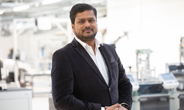 Dr Arivazhagan Anbalagan in a black suit and white shirt