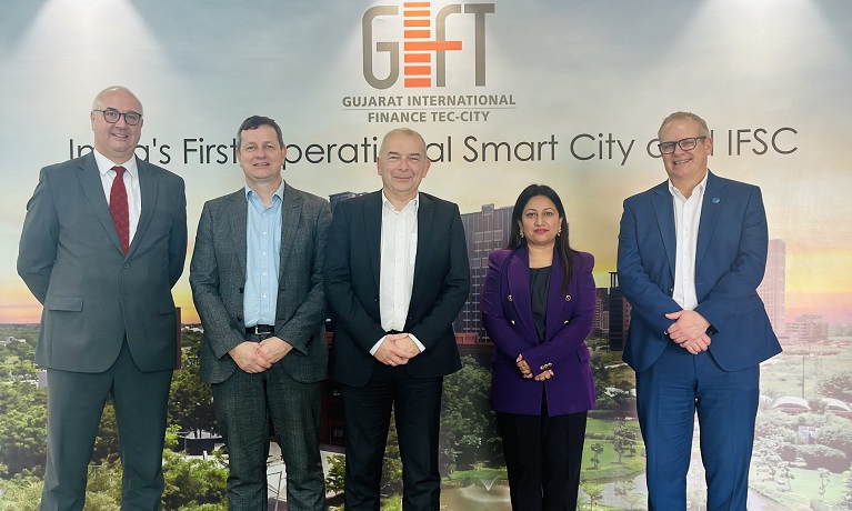 Five people stood in front of a GIFT City banner -  Steve Hickling, British Deputy High Commissioner to Gujarat and Rajasthan; Richard Wells; Coventry University's Deputy Vice-Chancellor (International); Coventry University's Vice-Chancellor and Group CEO, John Latham; Regional Managing Director of Coventry University's India Hub, Leena Arora Kukreja; Coventry University's Deputy Vice-Chancellor (Research)