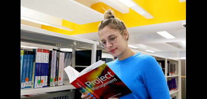 Student Alexandra reading a project management book 