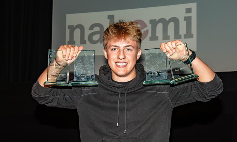 Harry Tatem holds up four of his five awards