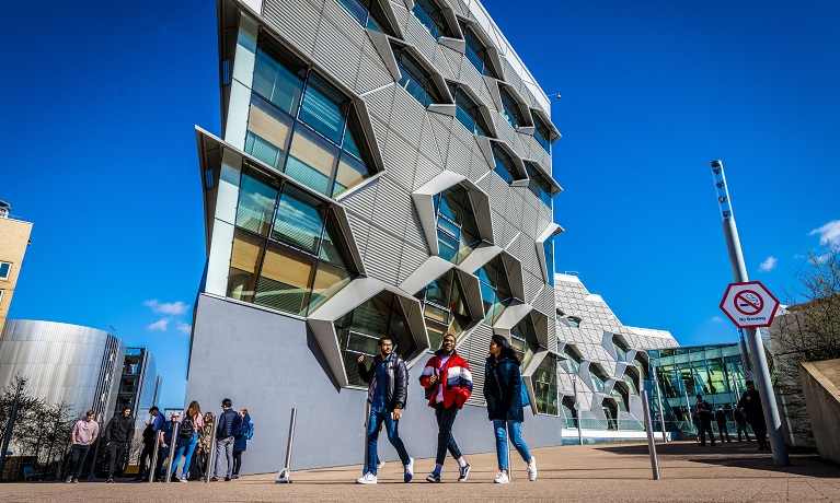 Students walking in front of Coventry University's Frank Whittle building