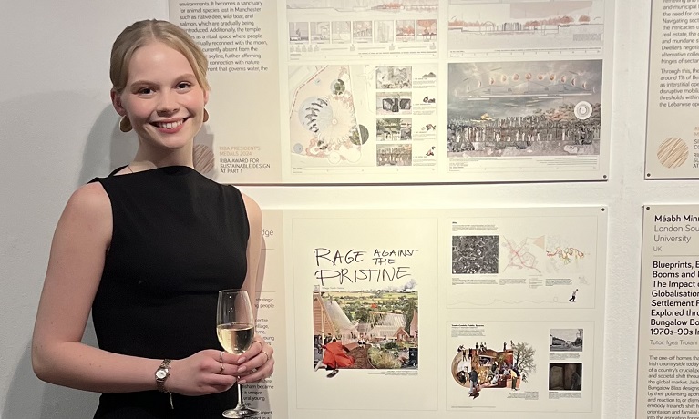 A female student standing in front of her design