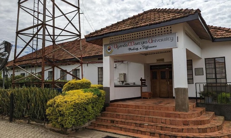 A campus building with a Uganda Martyrs University sign on it