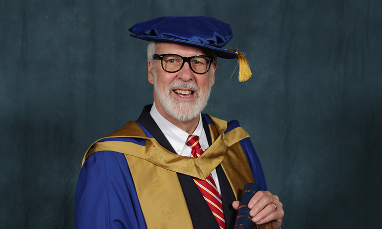 Dr Paul LeBlanc in his graduation gown and hat as he's awarded his honorary doctorate