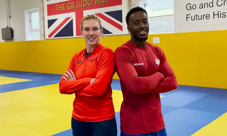 Coventry University Graduates Emma and Jamal stand side by side in the gym