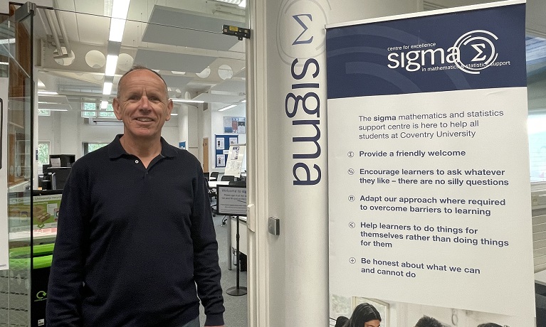 Dr Alun Owen in a dark jumper outside the sigma mathematics and statistics support centre