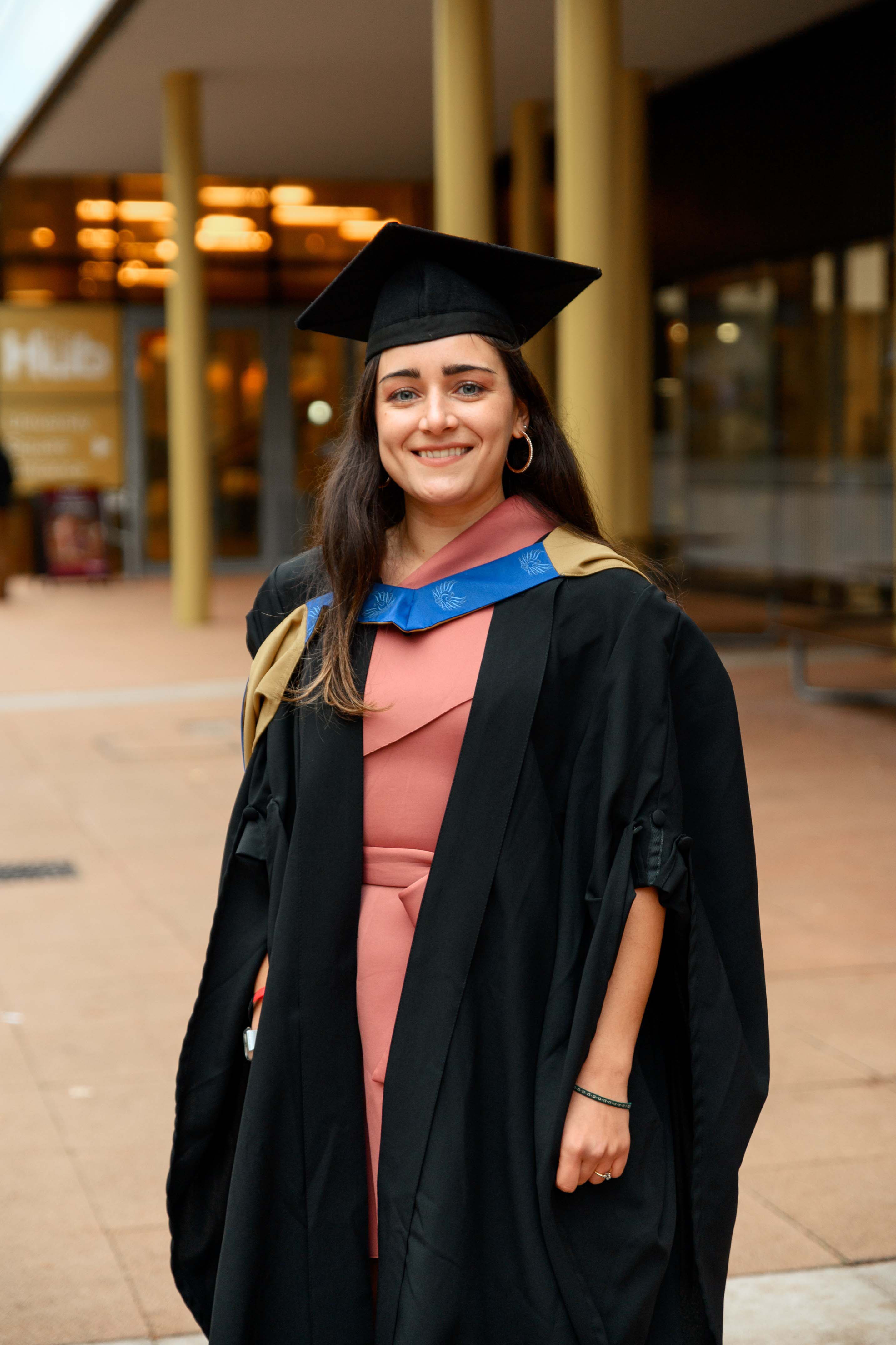 A picture of Emma Vizzino wearing graduation robes