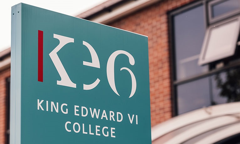 A sign showing the logo of King Edward VI College in Nuneaton