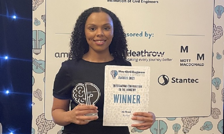 Coventry Graduate Abi Tetteh holding her award certificate at the awards ceremony