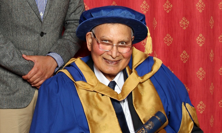 A man sitting down in ceremonial robes 