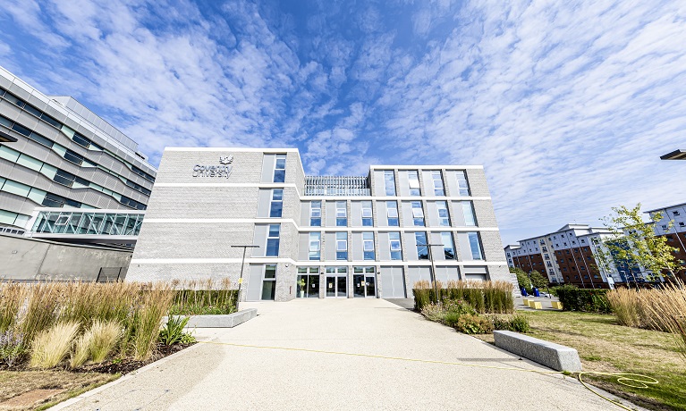 Coventry University's Beatrice Shilling building in the sunshine with a blue sky behind it