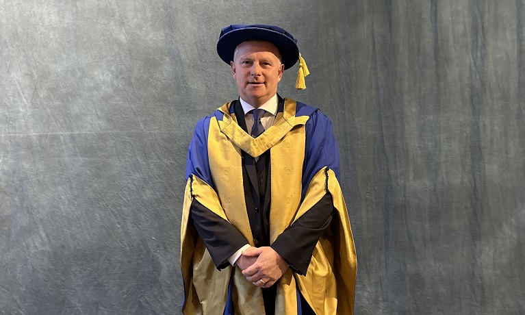 Mark Robins in his graduation gown after collecting his Honorary Doctorate from Coventry University