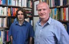 Kenna and Mac Carron researchers portrait stood in front of a book case