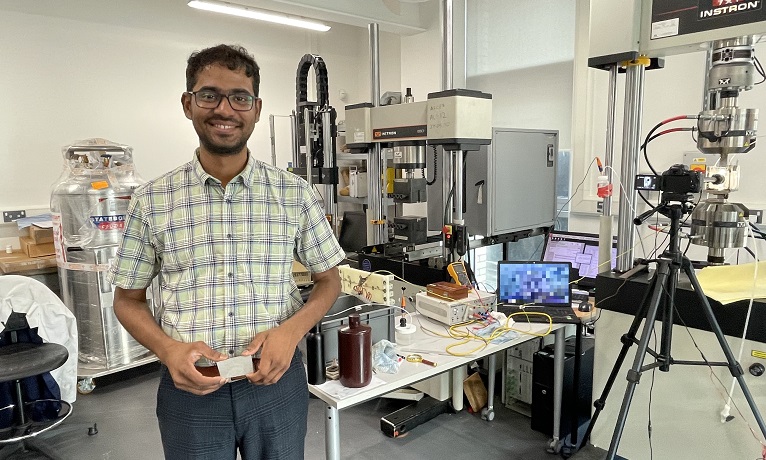 Dr Ashwath Pazhani stood in a lab at Coventry University and holding a piece of the new material he has created