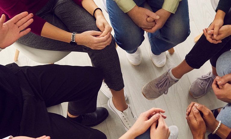 A group of people with their hands in a circle