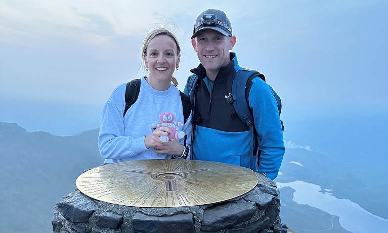 Amy and Ryan Jackson at the top of a mountain