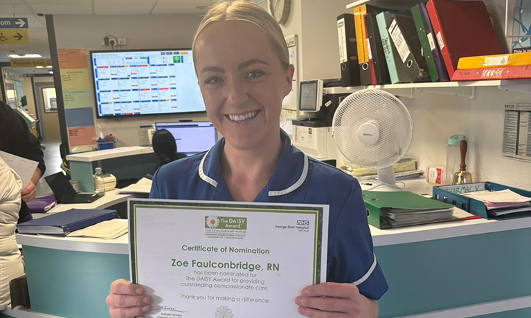 Zoe holding her award certificate