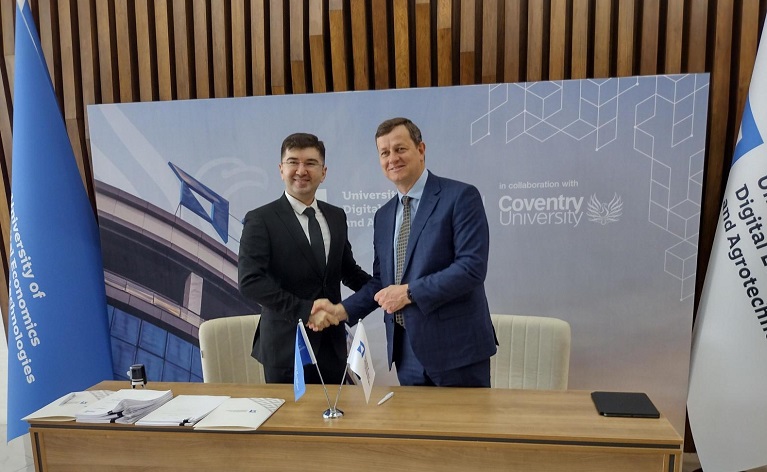 Two men shaking hands at the signing ceremony