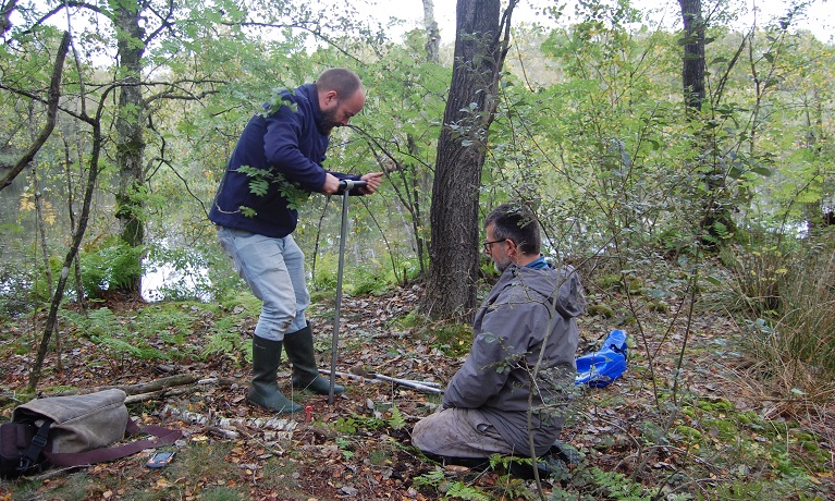 Two men at a bog site with digging equipment