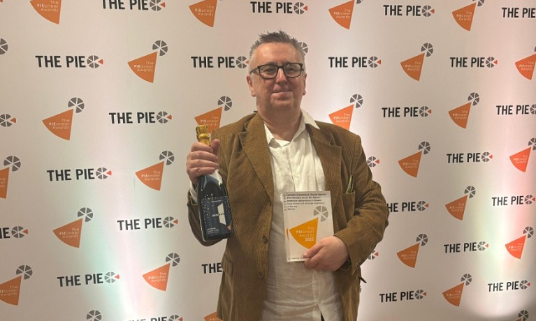 Tom Gorman holding the award