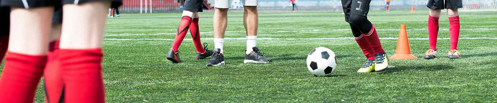 Children playing football on a pitch