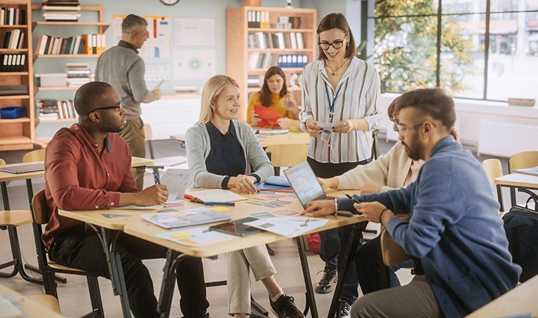 A group of people sitting at a desk