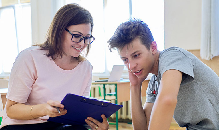 A teacher helping a student