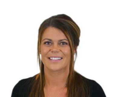 Charlotte Kane wearing a dark top against a white background.