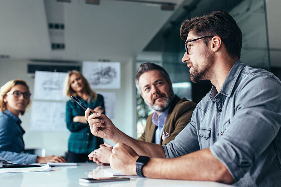 Staff members in discussion in a meeting room.