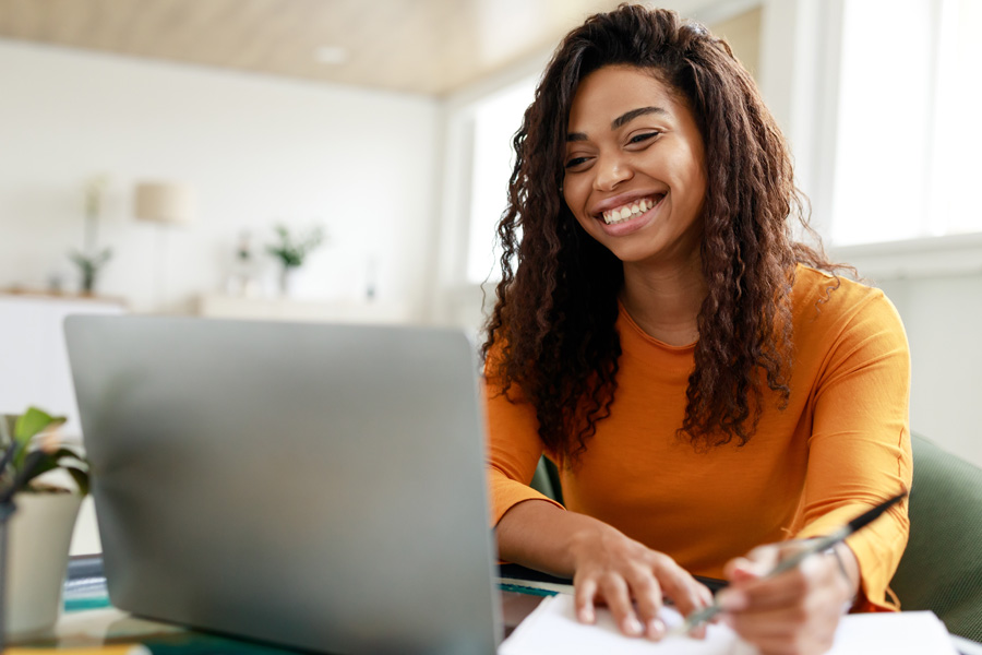 A young teacher using a laptop.