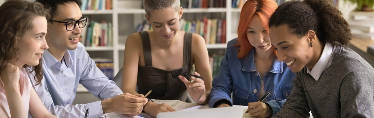 A group of university-aged students studying around a table.