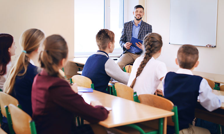 A teacher in a classroom with students