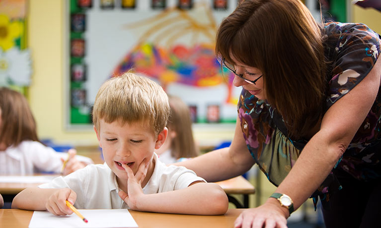 A teacher in a class teaching