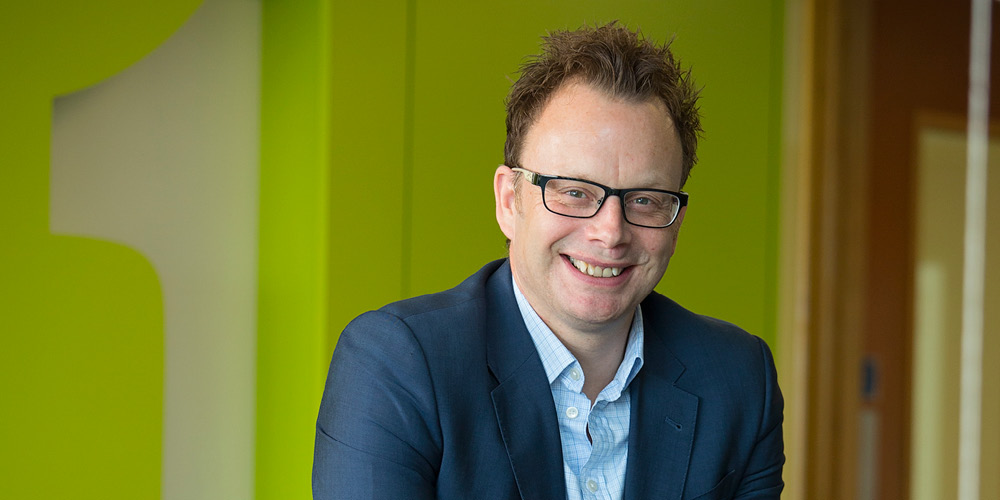 Portrait of Paul Fairburn with a green background