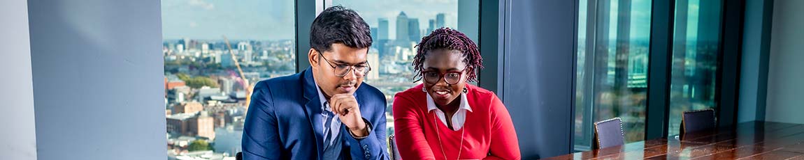 Two students talking inside of a Coventry University London building